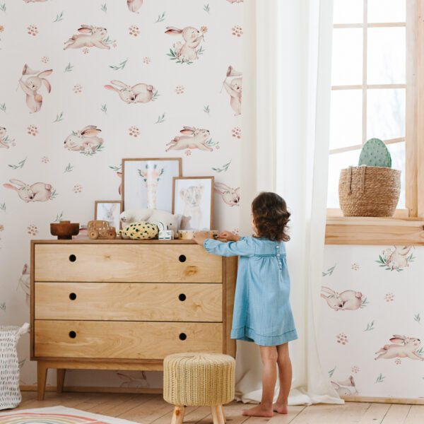 Little girl wearing light blue dress playing in children room scandinavian style. Eco friendly children room decor